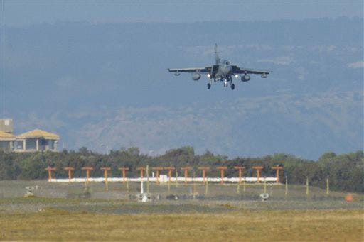 A British Tornado warplane lands at the RAF Akrotiri, a British air base near costal city of Limassol, Cyprus, Thursday, Dec. 3, 2015, after arriving from an airstrike against Islamic State group targets in Syria. British warplanes carried out airstrikes in Syria early Thursday, hours after Parliament voted to authorize air attacks against Islamic State group targets there. (AP Photo/Pavlos Vrionides)