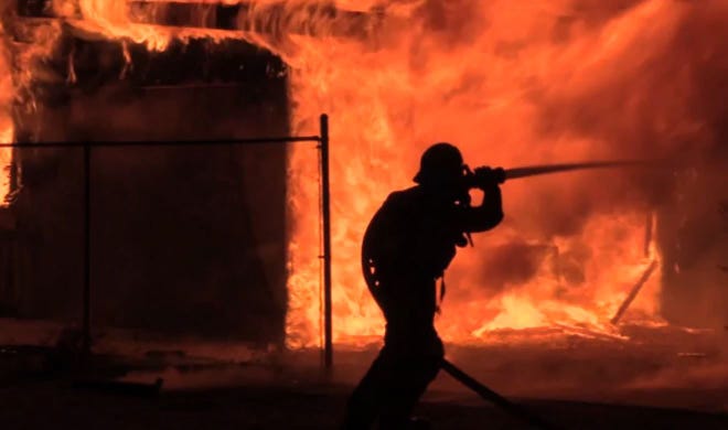 San Bernardino County Fire Department firefighters battle a fire that burned a detached garage in Hesperia early Thursday. Screengrab from video by Jose Gonzalez; visit vvdailypress.com to see the full video.