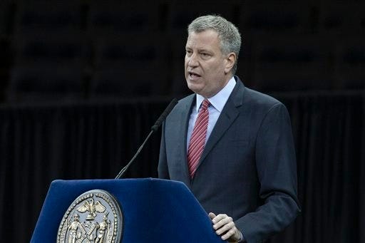 File-This Dec. 29, 2014, file photo shows New York City Mayor Bill de Blasio speaking during a New York Police Academy graduation ceremony at Madison Square Garden in New York. In the aftermath of last month's terror attacks in Paris, New York City not only bolstered security but quietly stepped up outreach efforts to its Muslim community. It aimed to calm fears about any hate-filled retaliation while trying to extend government services to a community that often has felt neglected. (AP Photo/John Minchillo, File)