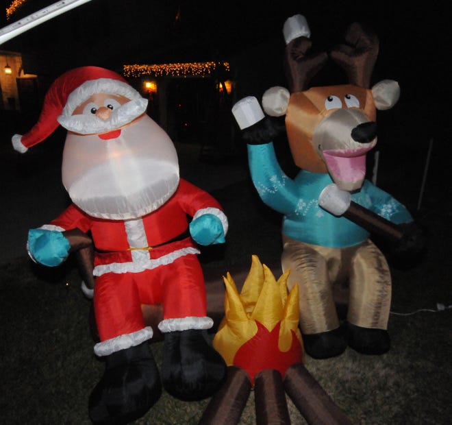 Santa and one of his reindeer sit on the lawn at 4 Auburn Lane, Delran.
