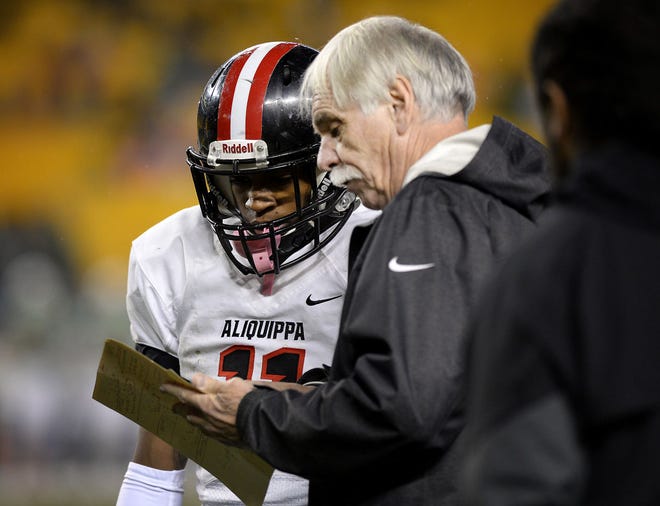 Aliquippa head coach Mike Zmijanac looks over a play with quarterback Sheldon Jeter during the class AA WPIAL Championship game, on Saturday, at Heinz Field in Pittsburgh.