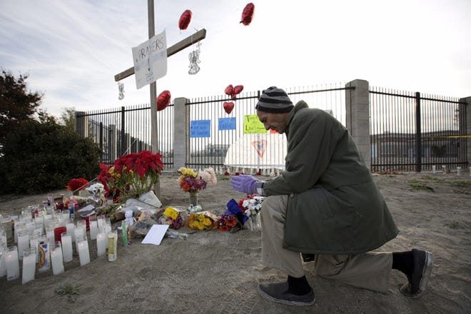George Solari says a prayer at a makeshift memorial for victims of the San Bernardino mass shooting Friday morning, Dec. 4, 2015, at the intersection of Waterman Ave and Orange Show Rd in San Bernardino, Calif. (Irfan Khan/Los Angeles Times/TNS)