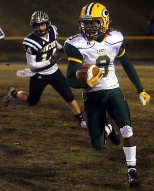 Crest's Devente Huskey (9) heads downfield for big yardage in Friday's 3AA semifinal at Concord. The Chargers won, 44-6, and will play for a second straight state title next Saturday in Chapel Hill.