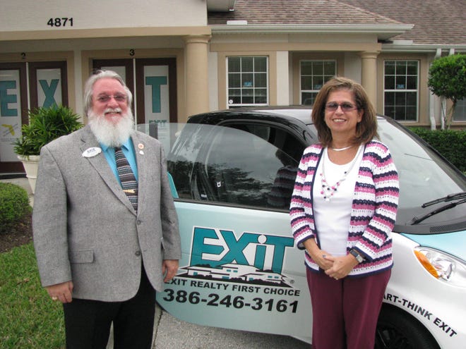 Husband and wife Ric and Honora Giumenta are co-owners of Exit Realty First Choice in Pam Coast. They help advertise the brokerage with a wrapped Smart car. NEWS-JOURNAL/BOB KOSLOW