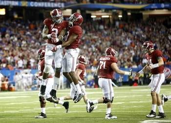Alabama Crimson Tide running back Derrick Henry (2) and Alabama Crimson Tide running back Kenyan Drake (17) celebrate after Henry scored a touchdown against the Florida Gators during the first half of the SEC Championship at the Georgia Dome on Saturday, Dec. 5, 2015 in Atlanta, Ga.