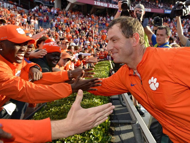 File photo - Clemson head coach Dabo Swinney celebrates with the fans after an NCAA college football game against South Carolina Saturday, Nov. 28, 2015, in Columbia, S.C. Clemson won 37-32.