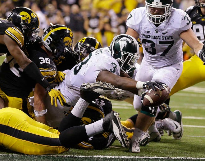 Michigan State's L.J. Scott runs for a 1-yard touchdown in the fourth quarter of the Big Ten championship game against Iowa on Saturday in Indianapolis. (AP Photo/Michael Conroy)