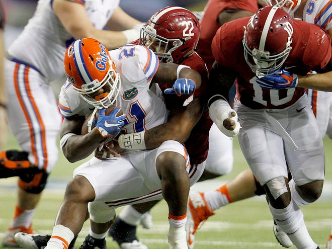 Florida Gators running back Kelvin Taylor is stopped for a loss by Alabama Crimson Tide linebacker Ryan Anderson during the second half of the SEC Championship at the Georgia Dome on Saturday, Dec. 5, 2015 in Atlanta, Ga. Alabama defeated Florida 29-15.