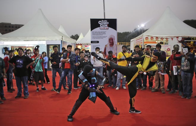 Fans dressed as their favorite comic characters reenact a scene Saturday at the Delhi Comic Con in New Delhi, India/ The Associated Press