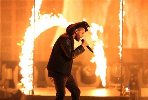FILE - In this Sunday, Nov. 22, 2015, file photo, the Weeknd performs at the American Music Awards at the Microsoft Theater in Los Angeles. Kendrick Lamar, Taylor Swift and the Weeknd have earned top nominations for the 2016 Grammy Awards, including album of the year. (Photo by Matt Sayles/Invision/AP, File)