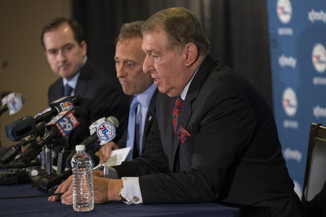 Naismith Memorial Basketball Hall of Fame member and Chairman of the Board of Directors for USA Basketball Jerry Colangelo, right, talks to the media as he will be joining the Philadelphia 76ers as the Special Advisor to the Managing General Partner and Chairman of Basketball Operations with co-Managing Owner Josh Harris, center, and general manger Sam Hinkie, left, beside him prior to the first half of an NBA basketball game against the San Antonio Spurs, Monday, Dec. 7, 2015, in Philadelphia. (AP Photo/Chris Szagola)