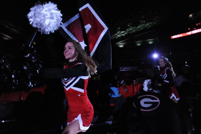 Cheerleaders lead the Georgia players onto the court during the Lady Bulldogs' game with the Georgia Tech Yellow Jackets at Stegeman Coliseum in Athens, Ga., on Sunday, November 22, 2015. (Photo by Sean Taylor)