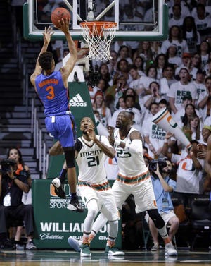Alan Diaz Associated Press Florida guard Chris Chiozza shoots as Miami center Tonye Jekiri defends during the second half of Tuesday night's game in Coral Gables. The Hurricanes won 66-55.