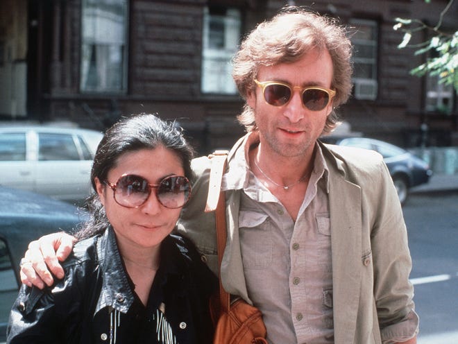In this Aug. 22, 1980, file photo, John Lennon, right, and his wife, Yoko Ono, arrive at The Hit Factory, a recording studio in New York City. The death of Lennon, shot 35 years ago, still reverberates as a defining moment for a generation and for the music world.
