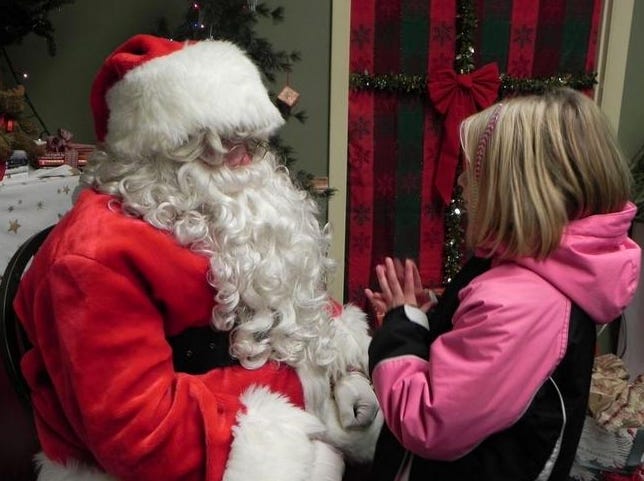 Santa speaks with a little girl during a previous Christmas by the River event. This year's festivities will kick off Thursday, Dec. 10 at 5 p.m.