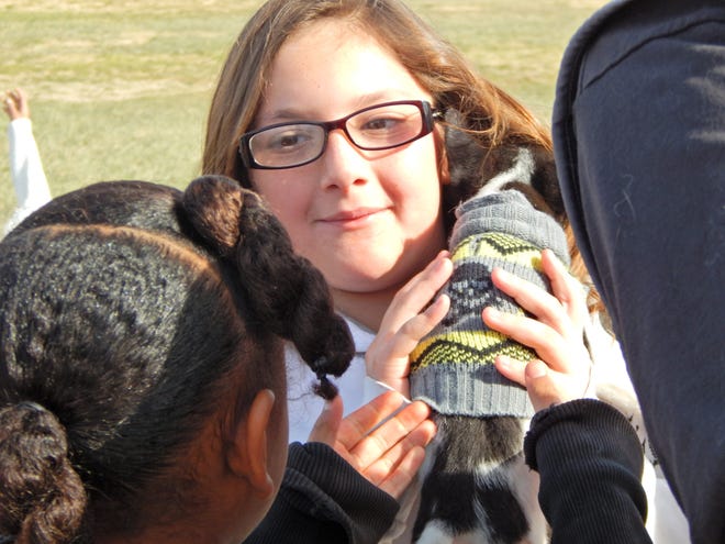 Crestline Elementary fourth-grader Jasmine Alawi holds a Chihuahua puppy during a check presentation Monday for the Barstow Humane Society animal shelter. 

Mike Lamb, Press Disaptch