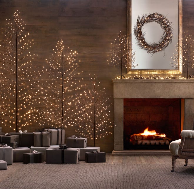 In a most modern decor, a grouping of warm starlit bark trees in a living space adds sparkle to a neutral palette, where monochromatic gray presents look ultra hip. The trees range from 2 to 11 feet tall at Restoration Hardware.