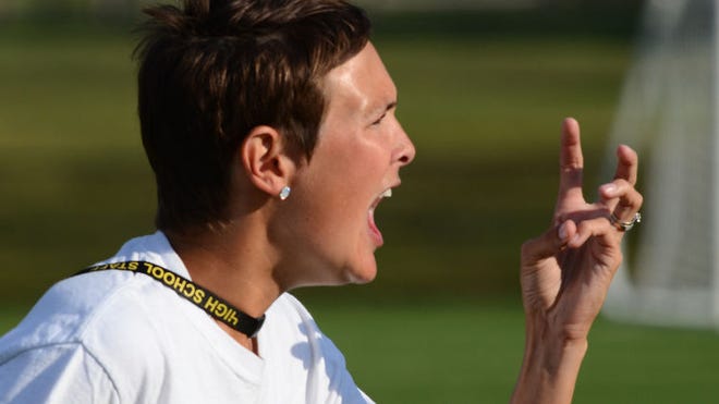 Moorestown High School's head varsity field hockey coach Ali Collins gestures to her players that there was only three minutes left in the second half in the non league game against Shawnee.