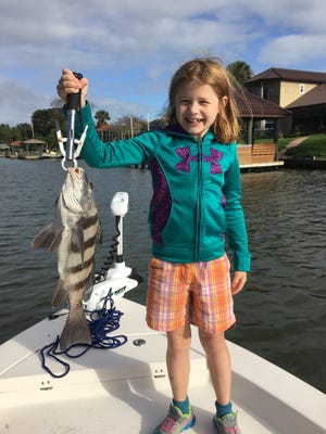 Kayla Pulvino, 8, from Baltimore, Maryland, holds up a 4-pound black drum she caught last week fishing the Intracoastal in Flagler Ciounty. NEWS-TRIBUNE/CAPT. MIKE VICKERS