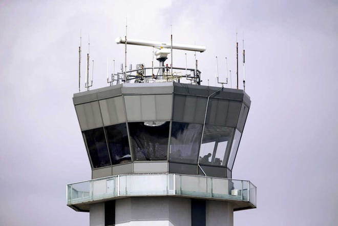 FILE - This March 12, 2013 file photo shows the air traffic control tower at Chicago's Midway International Airport. Thirteen of the nation's busiest air traffic control facilities, including in Chicago, are suffering from a shortage of air traffic controllers, a problem that demands "urgent attention," a government watchdog told lawmakers on Tuesday, Dec. 8, 2015. (AP Photo/M. Spencer Green, File)