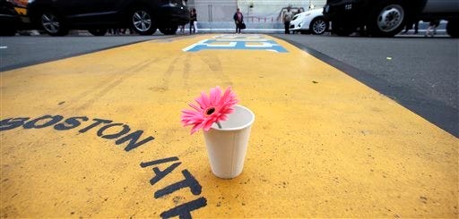 FILE - A single flower rests in a paper cup on the finish line of the Boston Marathon after the verdict in the penalty phase of the trial of Marathon bomber Dzhokhar Tsarnaev, Friday, May 15, 2015, in Boston.