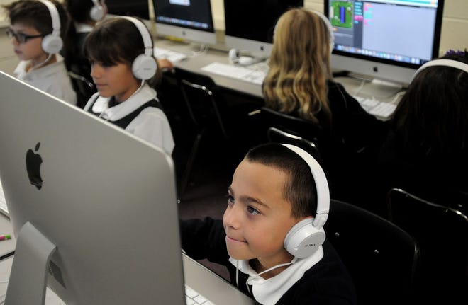 Caden Maldonado works on a coding project with his fourth-grade class at St. Mark School in Bristol on Wednesday, Dec. 9, 2015. The school has recently acquired brand new computers and interactive boards through their fundraising efforts.