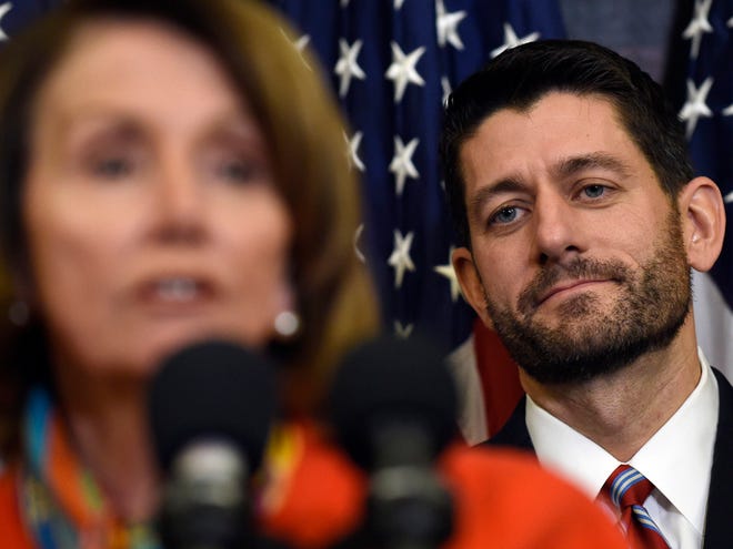 House Speaker Paul Ryan listens as House Minority Leader Nancy Pelosi speaks on Capitol Hill in Washington on Wednesday.