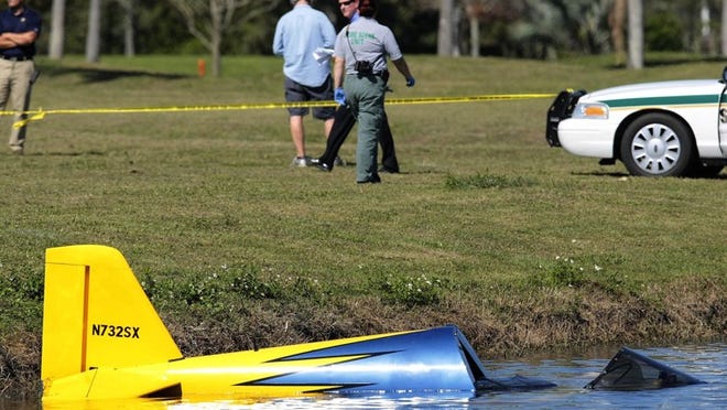 Palm Beach County Sheriff’s personnel work the scene of a fatal plane crash Feb. 17, 2014, in Wellington. A federal report says the airplane lost some engine power, but the pilot caused the crash. (Bill Ingram / Palm Beach Post)