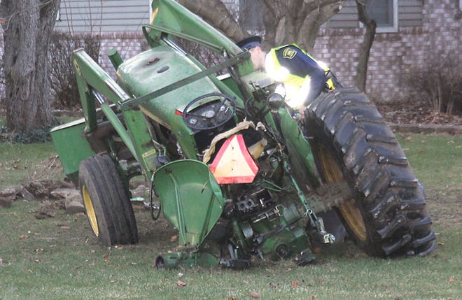 A tractor was pushed several feet and into a tree Tuesday after it was rear-ended by a truck.
