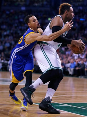 Golden State guard Step Curry, left, tries to strip the ball from Bosto's Jared Sullinger (7) during the first quarter of Friday's game at TD Garden.