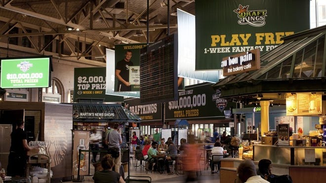 Advertisements for DraftKings, a leading daily fantasy sports site based in Boston, hang throughout the city’s South Station transit hub.