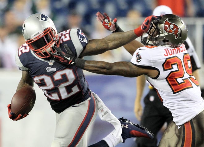 Tampa Bay's Leonard Johnson tries to bring down New England's Stevan Ridley in a 2013 preseason game. Johnson is now with the Patriots.