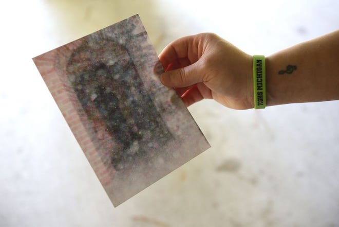 Nicole Beauchamp displays a photo she believes to be of a shadow person that she took at an old Civil War fort in Detroit six years ago.