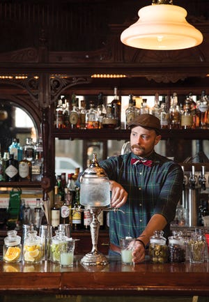 Blind Lady Tavern owner Seth Laufman makes a drink with the old school absinthe fountain.