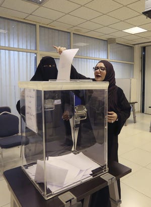 Saudi women vote at a polling center during the country's municipal elections in Riyadh, Saudi Arabia, Saturday, Dec. 12, 2015. (AP Photo/Aya Batrawy)