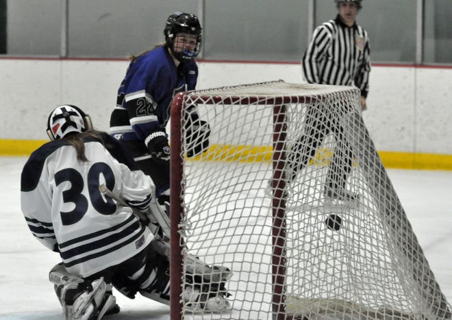 Berwick Academy's Alyssa Hulst, back, watches one of her three goals go past Pingree goalie CeCe Purcell during EIL action Saturday at the Dover Ice Arena. Mike Whaley/Fosters.com