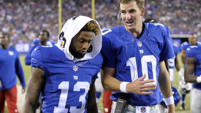 New York Giants quarterback Eli Manning (10) and Odell Beckham (13) talk while walking off the field after the first half of a preseason NFL football game in East Rutherford, N.J. (AP Photo/Bill Kostroun, File)