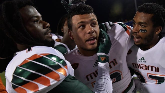DURHAM, NC - OCTOBER 31: Malik Rosier #12 of the Miami Hurricanes celebrates with teammates after a win against the Duke Blue Devils at Wallace Wade Stadium on October 31, 2015 in Durham, North Carolina. Miami won 30-27 on a last-second touchdown. (Photo by Grant Halverson/Getty Images)
