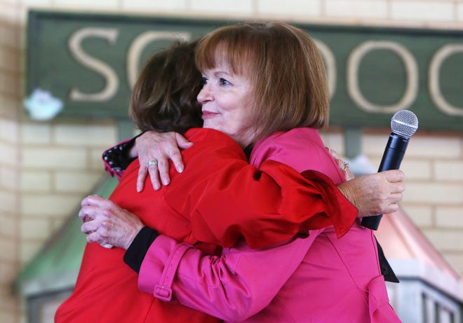 Terry Saban hugs Martha Cook after presenting her with the Lifetime Achievement Award for her 40 years of dedication with The Rise School during the third annual Teacher Appreciation Award luncheon sponsored by Nick's Kids at the Tuscaloosa River Market in Tuscaloosa, Ala. on Friday Dec. 12, 2014. The event honored 22 teachers and Terry Saban presented Martha Cook with a Lifetime Achievement Award trophy, inspired by the National Championship trophies won by the University of Alabama football team and coach Nick Saban. staff photo | Erin Nelson