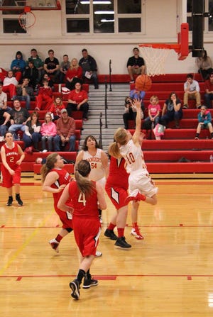 Junior Hailey Sims (10 in white) attempts a layup, following her drive through the paint. MATTHEW LOUNSBERRY PHOTO