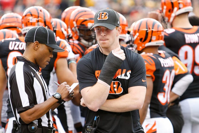 Cincinnati Bengals quarterback Andy Dalton walks the sideline with a cast on his throwing hand in the first half of an NFL football game against the Pittsburgh Steelers, Sunday, Dec. 13, 2015, in Cincinnati. (AP Photo/Frank Victores)