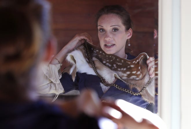 Pam Paquin tries on a fawn scarf and belt. File Photo/The Associated Press