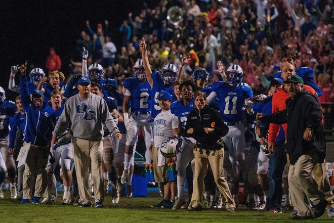 The Oconee County bench reacts to the 2-point conversion that won the game during a GHSA high school football game between the Jefferson Dragons and the Oconee County Warriors in Watkinsville, Ga., on Friday, October 30, 2015. (Taylor Craig Sutton/Staff, Taylorcraigsutton.com)