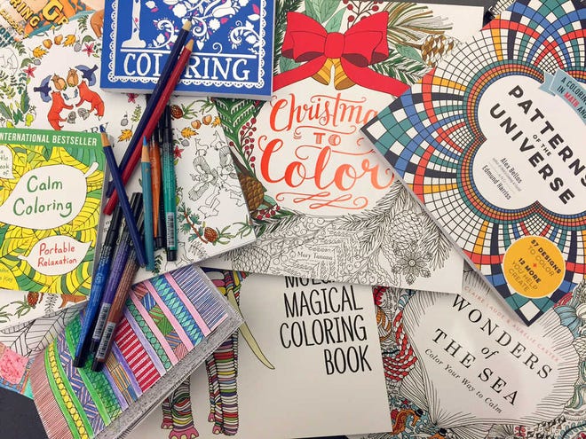 This Dec. 8, 2015 photo shows a display of adult coloring books and markers in New York. (AP Photo/Beth J. Harpaz)