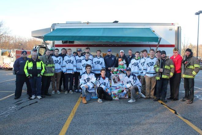 The York High School boys hockey team delivered more than 100 gifts for the annual Toys for Tots drive last weekend. Courtesy photo