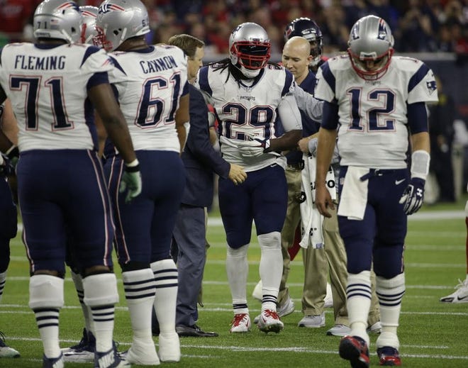 Running back LeGarrette Blount (29) walks off the field with trainers after injuring his hip on Sunday night against Houston. The Patriots placed him on season-ending injured reserve on Tuesday.