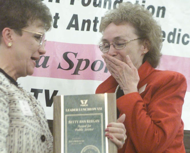 Winnebago County Coroner, Sue Fiduccia, (right) happily accepts her Betty Ann Keegan Award for Public Service from steering committee member Nancy Flanagan during the YWCA Leader Luncheon XXI at the Best Western Clock Tower Resort and Conference Center in Rockford on Monday, March 5, 2001. RRSTAR.COM FILE PHOTO