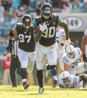 Gary McCullough/Correspondent -- 12/13/15 -- Jacksonville Jaguars defensive end Andre Branch (90) recovers an Indianapolis Colts fumble and runs 49 yards for a touchdown during the first half of NFL football action at EverBank Field in Jacksonville, Fla., Sunday, Dec. 13, 2015. (The Florida Times-Union, Gary McCullough)