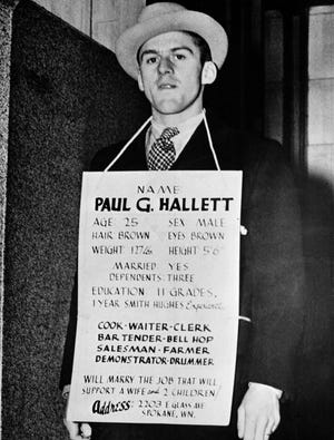 FILE - In this Dec. 9, 1937 file photo, Paul G. Hallett, 25, as he wears a sign stating his situation and qualifications as he looks for a job in Spokane, Wash. The US economy took a turn for the worse in 1937, with many blaming tighter Fed policy and a tougher budget stance by the government for the deterioration. On Wednesday, Dec. 16. 2015, the US Federal Reserve is expected to raise interest rates for the first time since 2006. (AP Photo, File)