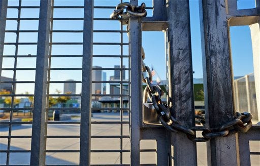 A lock holds the gate shut at Edward Roybal High School in Los Angeles, on Tuesday morning, Dec. 15, 2015. All schools in the vast Los Angeles Unified School District, the nation's second largest, have been ordered closed due to an electronic threat Tuesday. (AP Photo/Richard Vogel)